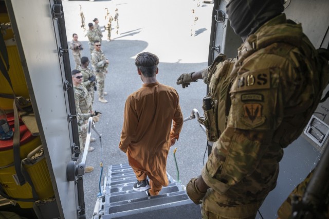 Evacuees arrive on a C-17 Globemaster III aircraft at Ali Al Salem Air Base, Kuwait, August 23, 2021. U.S. Air Force Airmen are assisting with evacuations of Americans and allied civilian personnel from Afghanistan.