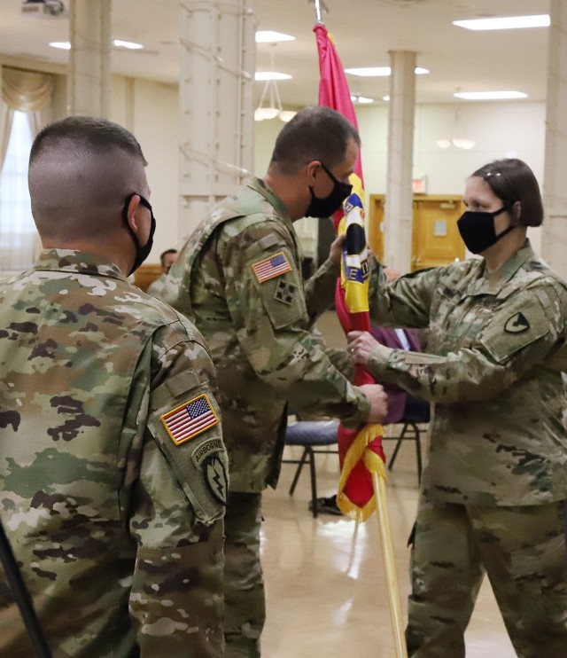 Command Sgt. Maj. Petra Casarez (right) accepts the Joint Munitions Command colors from Brig. Gen. Gavin Gardner (center), JMC commander, as outgoing Command Sgt. Maj. Brian Morrison (left) looks on at a change of responsibility ceremony August 24. JMC and its 17 subordinate arsenals, depots and ammunition plants produce, store, distribute and demilitarize all conventional munitions for the U.S. Department of Defense. The enterprise is accountable for $59 billion of munitions and missiles (U.S. Army photo by Shawn Eldridge).