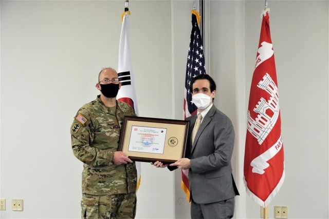 Dennis Headrick receives a certificate of recognition from Far East District Commander, Col. Christopher Crary, during graduation from the U.S. Army Corps of Engineers Leadership Development Program Level 2, July 19, 2021. (US Army photo by Far East District)