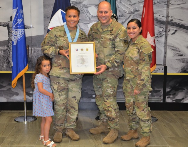 Sgt. 1st Class Mikaela Clark, provost sergeant, U.S. Army Sustainment Command, gathers for a photo with Kameron, her daughter, Col. Scott Kindberg, ASC chief of staff, and Sgt. Emily Cabrera, First U.S. Army, her fiancée, after being inducted...