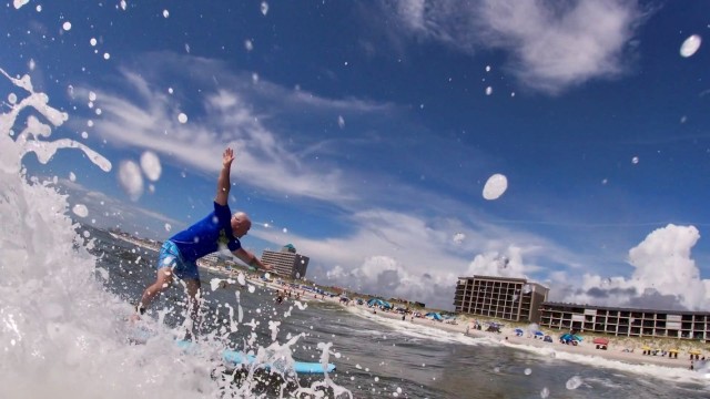 Staff Sgt. Judson Heard, a Soldier assigned to the Fort Bragg Soldier Recovery Unit, North Carolina, catches a wave at Carolina Beach on July 29 during an adaptive surfing event. (Photo courtesy of Lee Whitford)