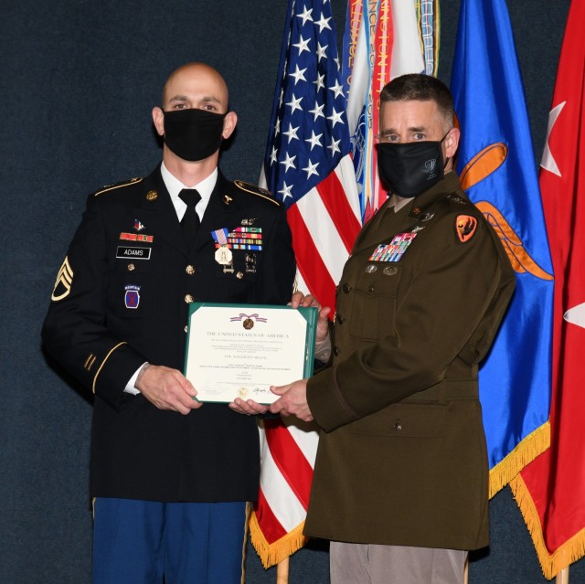 U.S. Army Staff Sgt. Travis M. Adams, who serves as a flight medic with Fort Rucker's air ambulance detachment, receives the Soldier's Medal from Maj. Gen. David J. Francis, U.S. Army Aviation Center of Excellence and Fort Rucker commander, for...