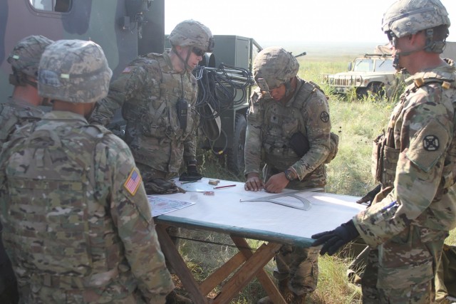 Spc. Teron Denmark, A Battery, 2nd Battalion, 2nd Field Artillery, uses a range deflection protractor to chart azimuth and deflection during direct fire training Aug. 27, 2021, at Fort Sill, Oklahoma. Soldiers still learn the basics for charting artillery fire as a backup in case modern methods fail to work.