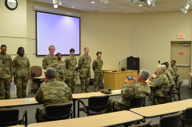 U.S. Army JROTC Commander Lt. Col. Elizabeth Peters, seated third from left, and her team review JROTC cadets knowledge of summer camp operational procedures at a STEM Day camp Aug. 5 at Fort Custer, Mich.