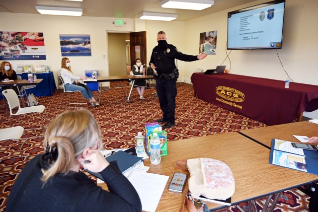 Scott Huntley, Presidio of Monterey police officer, speaks during the Presidio of Monterey Military Spouse Orientation at the General Stilwell Community Center, Ord Military Community, Calif., Aug. 23.