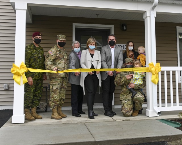 Sgt. Damian McGregor, his wife Rebekka, and their children help cut the ribbon on their new home. Fort Wainwright held a ceremony Wednesday marking the completion of construction on 32 brand-new, 3-bedroom homes for junior noncommissioned officers in the Bear Paw neighborhood. From left are Brig. Gen. Louis Lapointe, deputy commander of U.S. Army Alaska; Col. Nate Surrey, Fort Wainwright garrison commander; Phillip Carpenter, Lendlease chief operations officer; Carolyn Tregarthen, Lendlease managing director; Ron Johnson, North Haven Communities project director; and Sgt. Damian McGregor with his wife Rebekka and their children. (U.S. Army photo by Dan Nelson, Fort Wainwright Public Affairs Office)