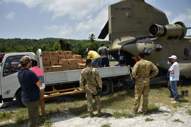 A U.S. Army CH-47 Chinook Helicopter crew and partner agencies deliver emergency medical equipment and food to Haitian citizens in impacted areas of Haiti, Aug. 23, 2021. The Coast Guard and partner agencies conducted humanitarian efforts in...