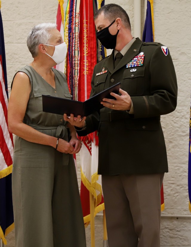 Brig. Gen. Gavin Gardner, commanding general of U.S. Army Joint Munitions Command, presents Kathy George-Reading with an award marking her induction into the Ammunition Hall of Fame August 26. George-Reading was honored for her leadership of the Conventional Ammunition Management program and serving on the forefront Ammunition Depot Automation and the Integrated Logistics Strategy.
