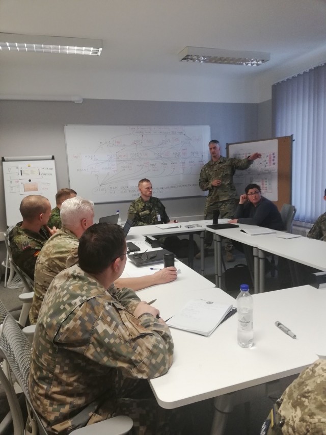 Lt. Col. Aaron Cornett, standing, leads classroom discussion in building a joint headquarters command and control structure, to students at the Baltic Defense College in Tartu, Estonia. Cornett and his colleague, Lt. Col Richard Towner, are the only two U.S. Army instructors at the college. (Courtesy photo)