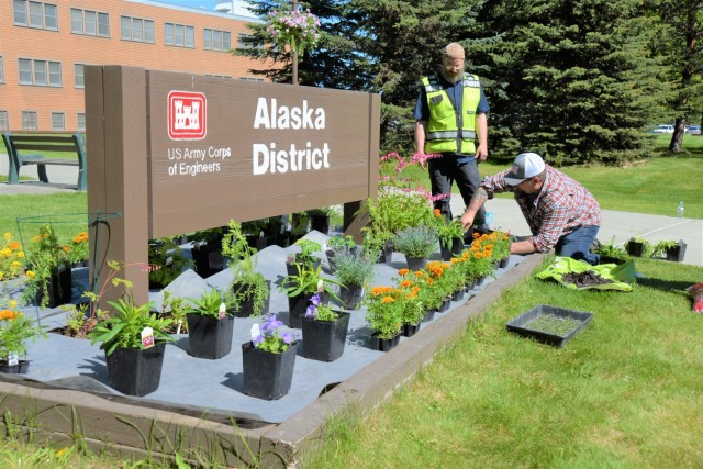 William “Eggy” Egeberg, facilities manager for the USACE Logistics Activity team in Alaska, and Mark Godfrey, contractor, plant summer flowers in the Alaska District headquarters front lawn’s flower box. Many of Egeberg’s daily tasks...
