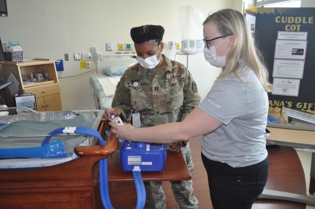 Martin Army Community Hospital Mother-Baby Unit CNOIC Capt. Katherine Basquill-White and Labor and Delivery Unit CNOIC Capt. Decilia Neely assemble the CuddleCot.