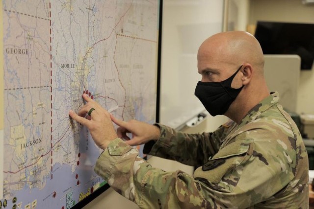 MOBILE, Ala. - Cpt. Russell Parman of the Alabama National Guard&#39;s 711th Combat Sustainment Support Battalion adds dots to a map tracking road closures and incidents due to Hurricane Ida.