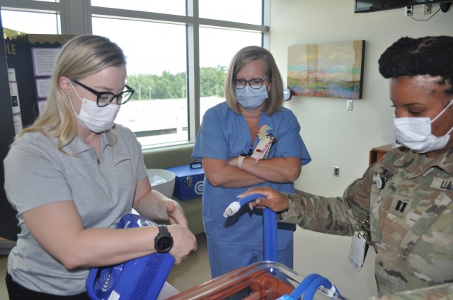 Martin Army Community Hospital Mother-Baby Unit CNOIC Capt. Katherine Basquill-White assembles the CuddleCot.