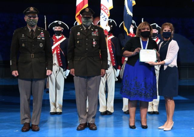 From left, U.S. Army Chief of Staff Gen. James McConville, left, Lt. Gen. Leslie C. Smith, the 66th Inspector General of the Army, Vanedra Smith, and Maria McConville stand after an awards presentation during Smith’s retirement ceremony at Conmy...