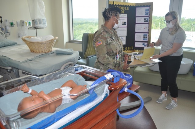 Martin Army Community Hospital's Labor and Delivery Unit CNOIC Capt. Decilia Neely and Mother-Baby Unit CNOIC Capt. Katherine Basquill-White train nurses on the CuddleCot.
