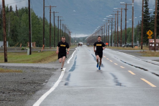 Col. Damon Delarosa (right), commander of the U.S. Army Corps of Engineers – Alaska District, and Capt. Justin Dermond (left), project engineer, race to the finish line of the two-mile run during the Army Combat Fitness Test on Aug. 17 at Joint...