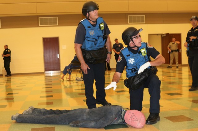 Left, Lt. Bryan Smart and Public Safety Officer Bradley Militano, both from the Sunnyvale Department of Public Safety (Fire) assess a simulated casualty as members of a Rescue Task Force during active-shooter response training, at the Sgt. James...