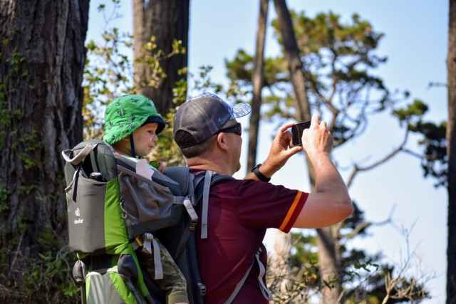 Lt. Col. Daniel Bolton, director of the Defense Language Institute Foreign Language Center’s Foreign Area Officer Program, takes a photo of the ocean view during the Volksmarch at the Presidio of Monterey, Calif., Aug. 28.