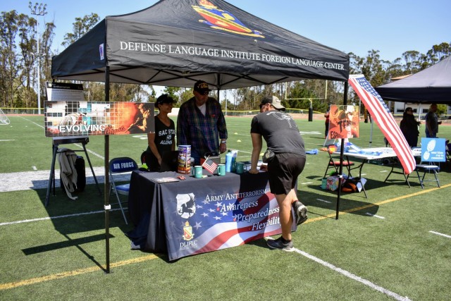 Janice Quenga, left, U.S. Army Garrison Presidio of Monterey antiterrorism officer, and Glen Harrison, Defense Language Institute Foreign Language antiterrorism officer, staff a table during the Volksmarch at the Presidio of Monterey, Calif., Aug....
