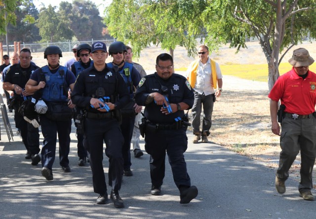 Left to right, Public Safety Officer S. Kotani, Sunnyvale Department of Public Safety (Law), co-leads a Rescue Task Force with Police Officer Alan Corpuz from the Mountain View Police Department as Sgt. Edward Durante, an exercise proctor from the Santa Clara County Sheriff’s Office, walks alongside during active-shooter response training, at the Sgt. James Witowski Armed Forces Reserve Center, in Mountain View, California, Aug. 26, 2021.