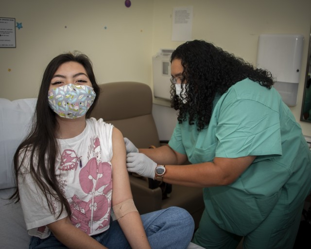 Patrinia Thomas, licensed vocational nurse, administers the COVID-19 vaccination to patient, Genesis Crockett, at Brooke Army Medical Center, Fort Sam Houston, Texas, Sep. 2, 2021. BAMC is now offering the COVID-19 vaccine to all hospital...
