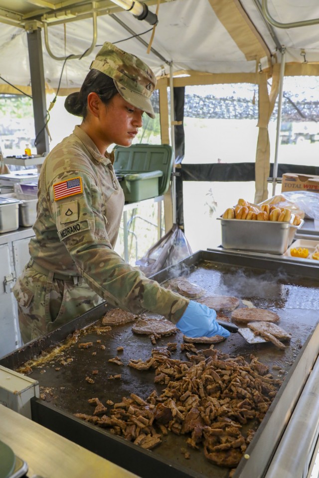 U.S. Army Pfc. Viviana Medrano, a culinary specialist assigned to 511th Quartermaster Company, Special Troops Battalion, 1st Sustainment Brigade, 1st Infantry Division, prepares philly cheesesteak during the 54th Annual Philip A. Connelly Awards...