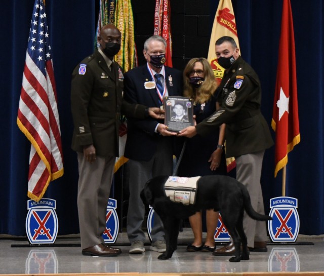 Maj. Gen. Milford H. Beagle Jr. and Command Sgt. Maj. Mario O. Terenas, 10th Mountain Division (LI) and Fort Drum commander and senior enlisted adviser, present Robert and Linda Ollis, parents of Staff Sgt. Michael H. Ollis, with the Warrior...