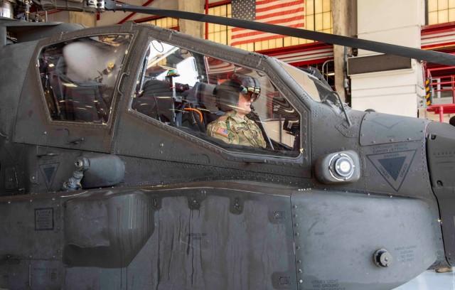 A US Army pilot observes the features of an enhanced Helmet Mounted Display from the front seat of an AH-64E Apache Helicopter during a capability demonstration July 13-4 Aug. at Redstone Army Airfield.  The event was hosted by The Apache Sensors Product Office in coordination with Redstone Test Center, the Future Vertical Lift- Cross Functional Team and a commercial vendor to showcase potential future cockpit technology.  (photo by Collin Magonigal)
