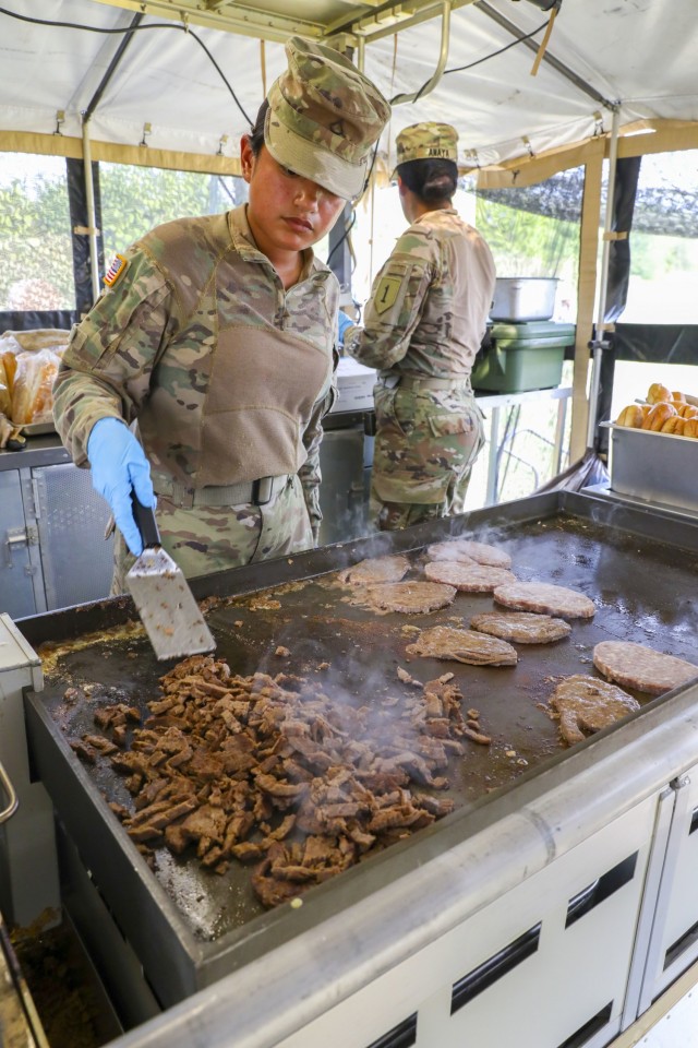 U.S. Army Pfc. Viviana Medrano, a culinary specialist assigned to 511th Quartermaster Company, Special Troops Battalion, 1st Sustainment Brigade, 1st Infantry Division, cooks philly cheesesteaks during the 54th Annual Philip A. Connelly Awards...