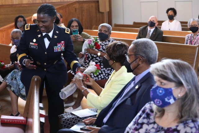 Lt. Gen. Donna Martin, Army inspector general, hands out bouquets of flowers to female family members who had an impact in her life during her swearing in and promotion ceremony on Sept. 2, 2021. Martin was continuing the tradition of giving flowers to honor her late mother, who passed away in January 2019. 