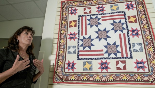 Diane Murtha explains the Stars of Liberty Quilt currently on display at the Pentagon Quilts memorial in Washington, D.C., Aug. 20, 2021. The quilt is a collective project by the Black Forest Quilt Guild, a group Murtha and more than 70 German and...