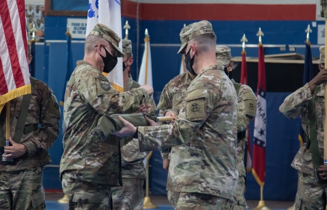 Brig. Gen. Justin M. Swanson and Command Sgt. Maj. Keith A. Gwin, the command team for 310th Expeditionary Sustainment Command, case their unit colors during a transfer of authority ceremony at Camp Arifjan, Kuwait, on Aug. 28, 2021. The ceremony was symbolic of 310th ESC transferring authority of the 1st Theater Sustainment Command’s operational command post mission to the 3rd Expeditionary Sustainment Command. (U.S. Army photo by Sgt. 1st Class Mary S. Katzenberger)