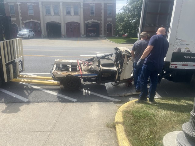 A New York Police Department parking enforcement vehicle that was crushed when the Twin Towers of the World Trade Center collapsed in Manhattan on 9/11 is unloaded outside the New York State Military Museum in Saratoga Springs, New York, Aug. 16,...