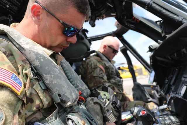 Louisiana National Guardsmen Chief Warrant Officer 3 Cody Davis (left) and Chief Warrant Officer 3 Ronald Cole (right), UH-60 Black Hawk helicopter pilots with the 2-238th General Support Aviation Battalion from Pineville, Louisiana, prepare for departure as they continue search and rescue missions throughout the southeastern part of the state after Hurricane Ida, Sept. 3, 2021. (U.S. Army National Guard photo by Staff Sgt. Gregory Stevens)