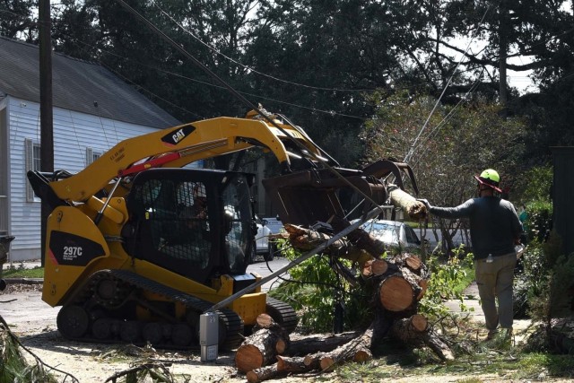 Members of the 202nd Rapid Engineer Deployable Heavy Operational Repair Squadron Engineers (Red Horse) partnered with the 159th Civil Engineering Squadron and New Orleans Parks and Parkways to clear debris from roads in New Orleans, Sept. 4, 2021....