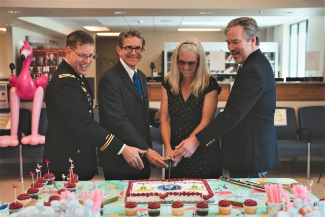 Cutting the cake to celebrate the memorialization of the Lefler Dental Clinic on Joint Base Lewis-McChord, Wash., after the late, retired Maj. Gen. Billie B. Lefler are, left to right:  Dr. (Col.) Kendall Mower, former commander of the Joint Base Lewis-McChord Dental Health Activity, retired Col. Tom Lefler, Tracey Salter, and Dr. Mark Lefler, the honoree&#39;s children.