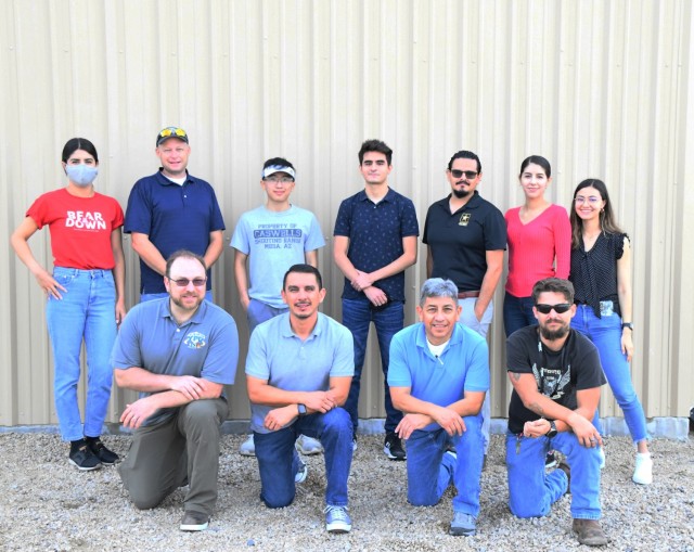 Russell Gee and Esteban Cook (top center) were embedded into the Instrumentation division at Yuma Proving Ground during their 10-week summer internship. (Top, left to right) Maria Villegas, Steve Taylor, Russell Gee, Esteban Cook, Jose Rodriquez, Daniela Villegas, Yelitza Candelas (Bottom, left to right) Lance Kerestes, Jacob Lopez, Ruben Hernandez, Justin Warren
