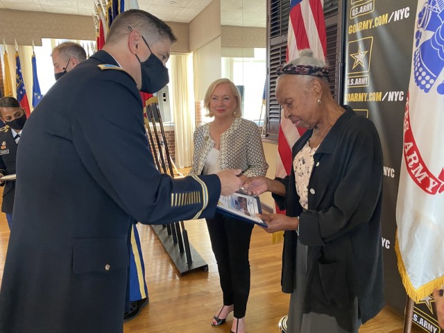 Col. Craig Martin, Fort Hamilton Garrison Commander, presents guest speaker Lorraine West with a token of appreciation at the Women’s Equality Day Observance held at the Community Club on Fort Hamilton, N.Y., Aug. 31, 2021.