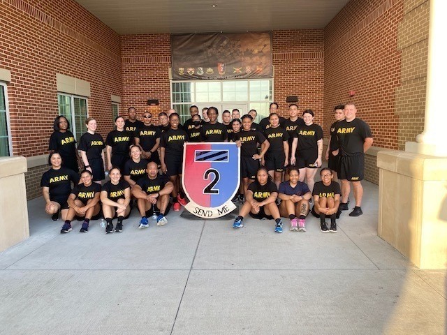 Soldiers assigned to 2nd Armored Brigade Combat Team, 3rd Infantry Division, pose for a group photo after a unit physical training session in honor of the staff changeover of the officer in charge of the brigade human resource office at Fort...