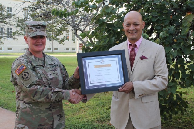 Dr. Joseph Cerna, principal of Fort Sam Houston Elementary School, presents the Pete Taylor Partnership of Excellence award for Outstanding Community Partnership K12 to Col. Alicia M. Masson, commander of U.S. Army Environmental Command, during a...