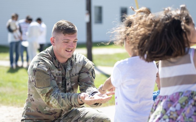 Spc. Joe Belles, a chemical, biological, radiological, and nuclear specialist for the 10th Chemical Company, 22nd Chemical Battalion, 48th Chemical Brigade, plays with Afghan evacuee children Sept. 7, 2021, at Fort McCoy, Wis., in support of...