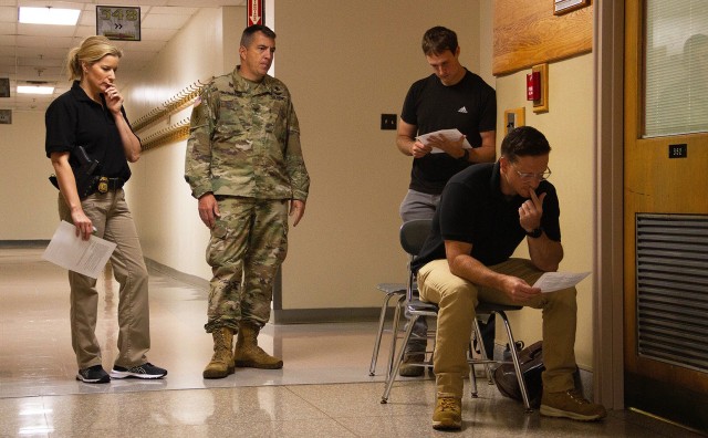 Special Agent Audrey Hall (left), with the Department of Homeland Security, and Col. Andrew Hagemaster, the PL 100 (General Psychology for Leaders course) program director at the Department of Behavioral Sciences & Leadership (second from left),...