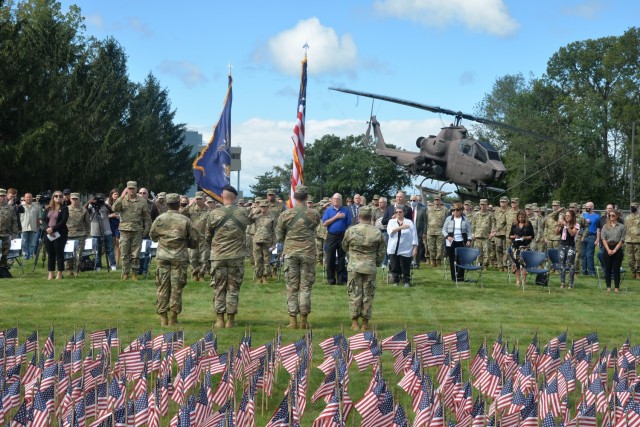The color guard presents the flag during a 9/11 remembrance ceremony at New York National Guard headquarters in Latham, New York Sept. 10, 2021. The ceremony took place in front of a backdrop of 2,977 small American flags representing each of the...