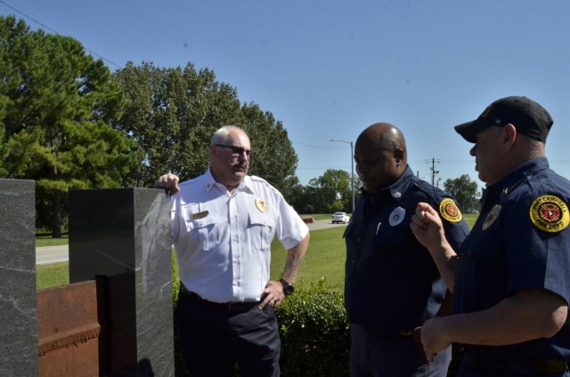 Fort Campbell Fire and Emergency Services employees who worked at the installation on Sept. 11, 2001, reflect on the terrorist attacks nearly 20 years later at a monument partially constructed using recovered steel from the World Trade Center located outside Fire Station 1. Pictured are Deputy Fire Chief Benjamine Peetz, left, Firefighter/EMT Vince McKissic and Fire Capt. Clint Hale.