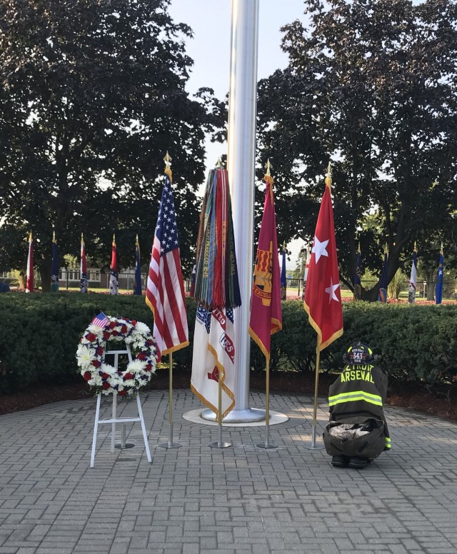 The Detroit Arsenal installation flag pole with a wreath commemorating all who perished Sept. 11, 2001 and a fireman&#39;s helmet to honor the first responders.