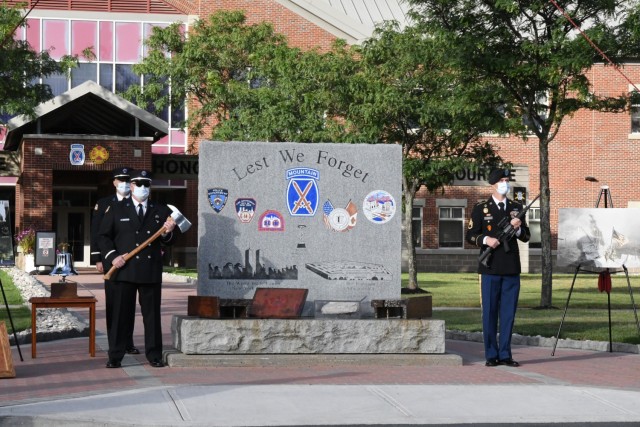 Fort Drum community members joined fire and law enforcement personnel Sept. 10 at the “Lest We Forget” monument outside Clark Hall to reflect on the 20th anniversary of 9/11. (Photo by Mike Strasser, Fort Drum Garrison Public Affairs)