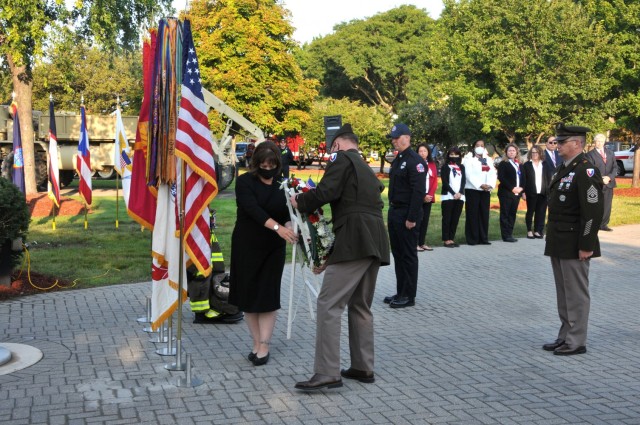 Maj. Gen. Darren Werner and Garrison Manager Carrie Mead place a wreath commemorating all who perished in the 9/11 attacks.