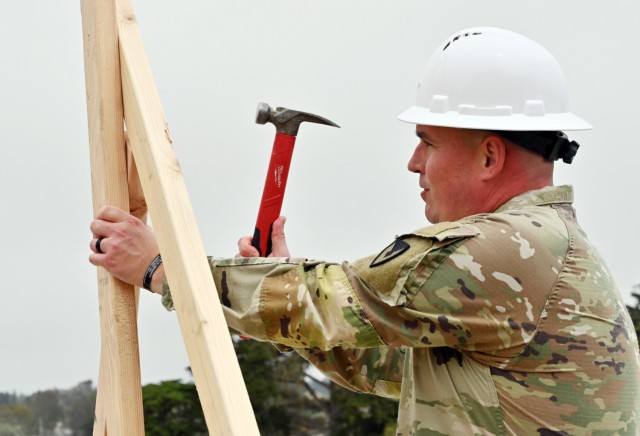 Command Sgt. Maj. Robert Londers, command sergeant major, U.S. Army Garrison Presidio of Monterey, hammers a nail to help brace the first vertical wall during the Lower Stilwell Going Vertical ceremony at the Ord Military Community, Calif., Sept. 8.