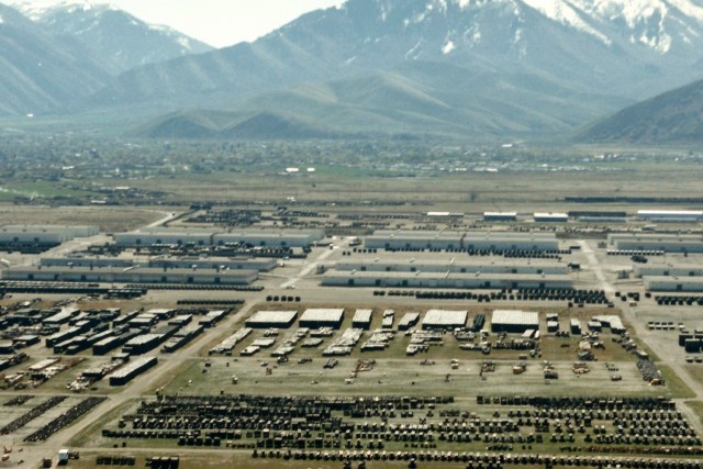 This photo was taken in July 1987.  It is an aerial view of the former supply and industrial areas at Tooele Army Depot.  The leaseback buildings discussed are the top six gray buildings in the center of the photo. One of the former uses for these facilities was vehicle rebuild and maintenance in the 1950s. (Photo courtesy of the U.S. Army.)