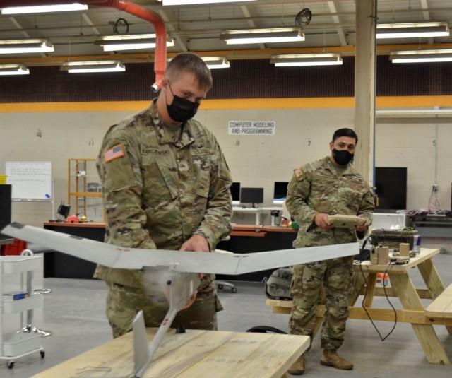 Chief Warrant Officer 2 Ron Rivera, unmanned aircraft systems operations officer, 2nd Brigade Combat Team, 101st Airborne Division (Air Assault), tests an RQ-118 Raven’s functionality Aug. 31 after fitting it with a 3D-printed prototype propellor system, while Sgt. Scott Karczewski, 2nd Battalion, 502nd Infantry Regiment, 2nd BCT, holds the aircraft steady. The project is one of several Soldier-led initiatives being developed through the EagleWerx Applied Tactical Innovation Center, which opened its physical location in August.